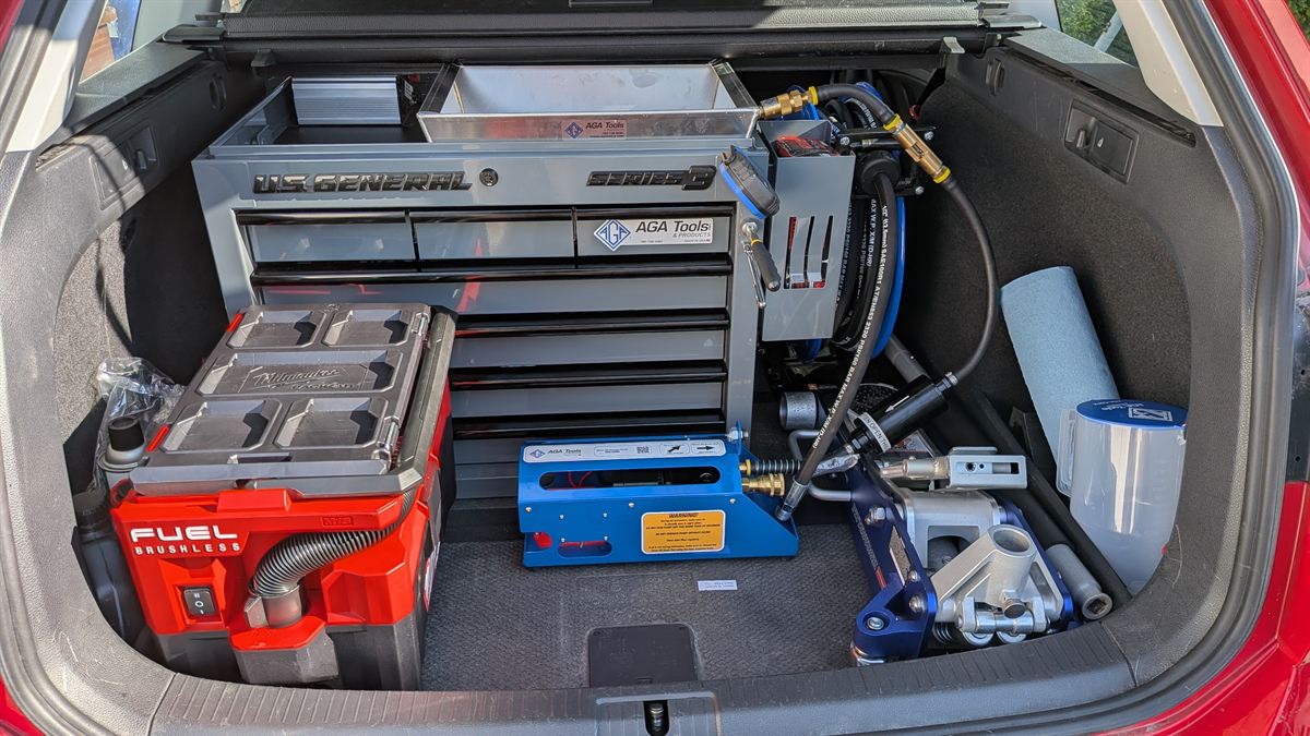 The back of our service vehicle: tool chest, oil vacuum unit, floor jack and supplies, ready for the job.