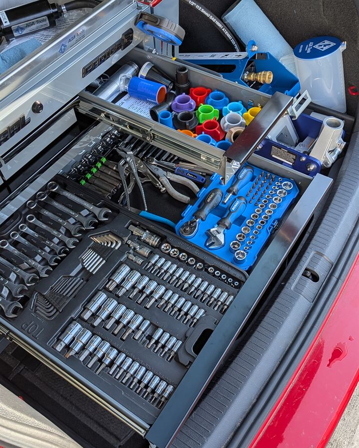 Tool chest drawers with socket and wrench sets.