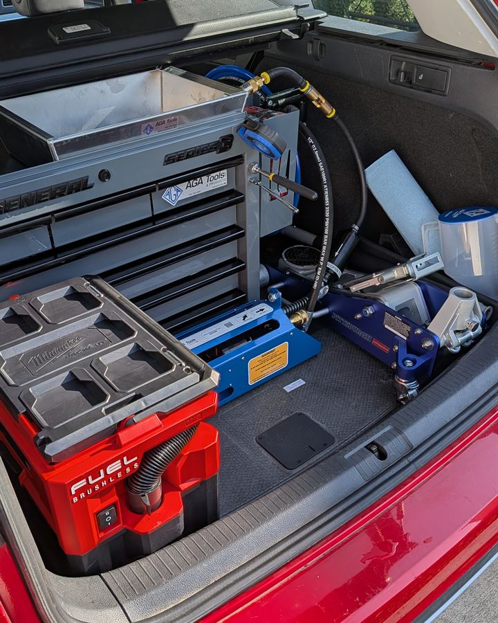 Closed tool chest, oil vacuum unit and jack in the back of our service vehicle.