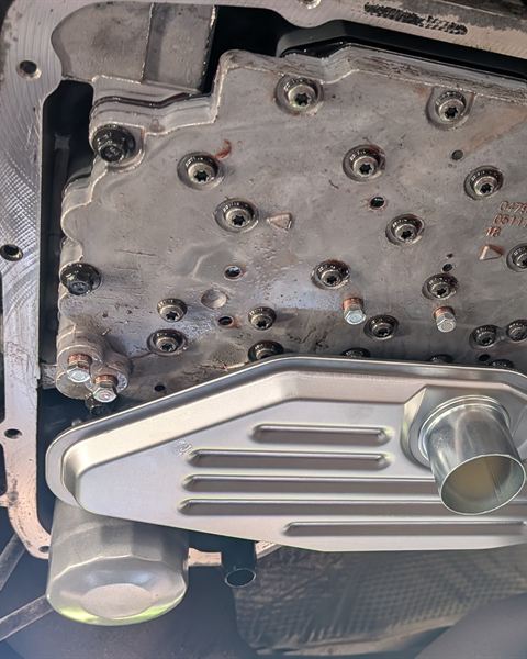 Transmission valve body with a new filter installed, seen from under the car.