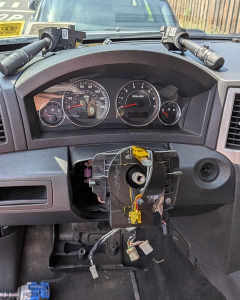 Steering wheel removed, showing the clock spring on the steering column.