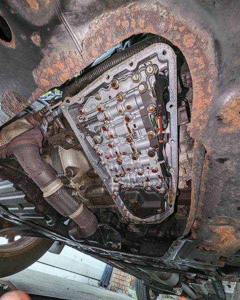 Underside of a car with the CVT pan removed, showing the valve body.