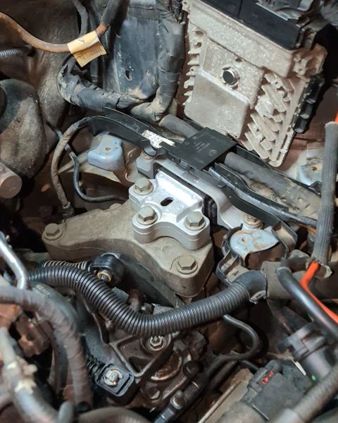 Engine bay with a new engine mount installed.