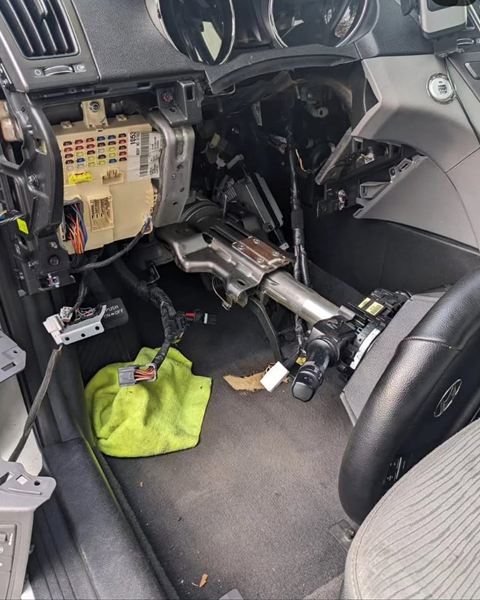 Dashboard panels removed to reach the steering column and wiring.