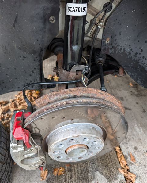 Wheel hub with a strut, brake caliper and rotor in place.