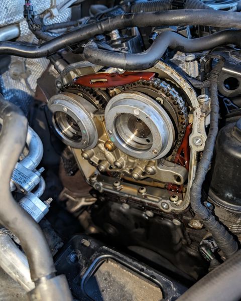 Timing chain and cam gears exposed with the timing cover removed.